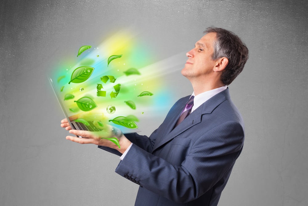Handsome businessman holding laptop with recycle and environmental symbols-2